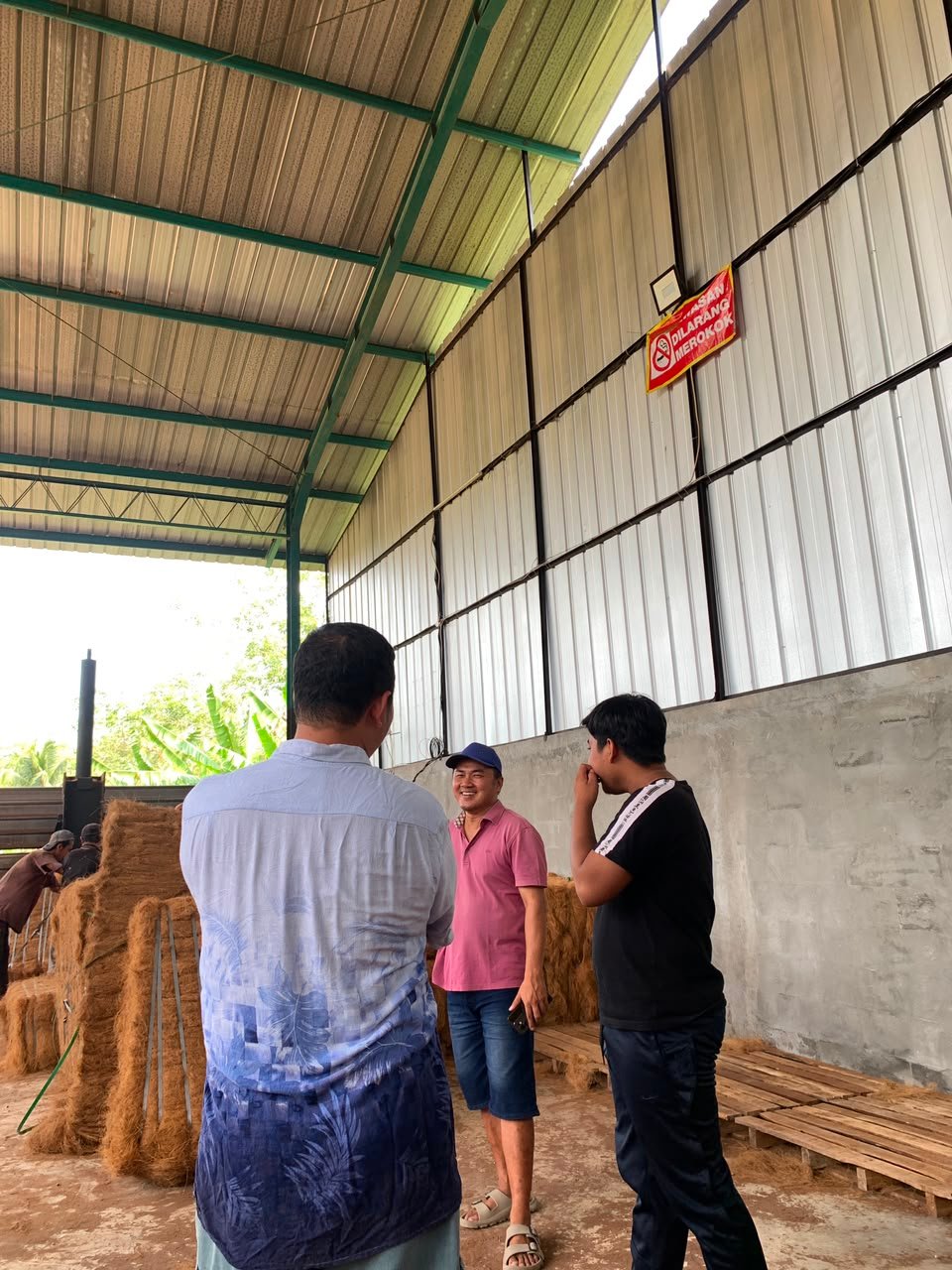 Tim berdiskusi di gudang produksi